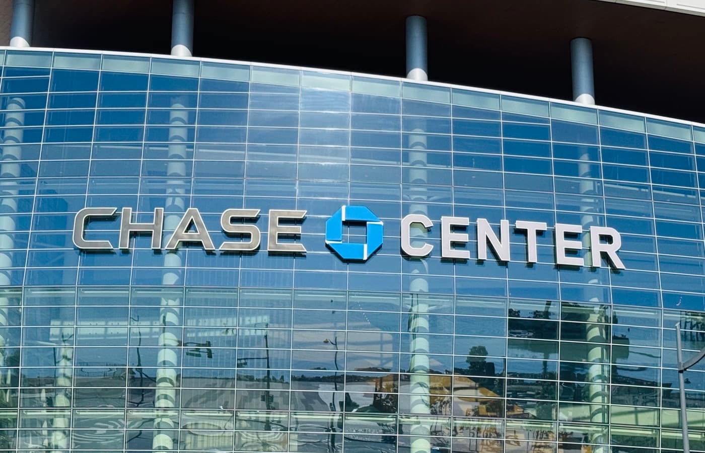 The glass exterior and illuminated Chase Center sign in San Francisco’s Mission Bay.