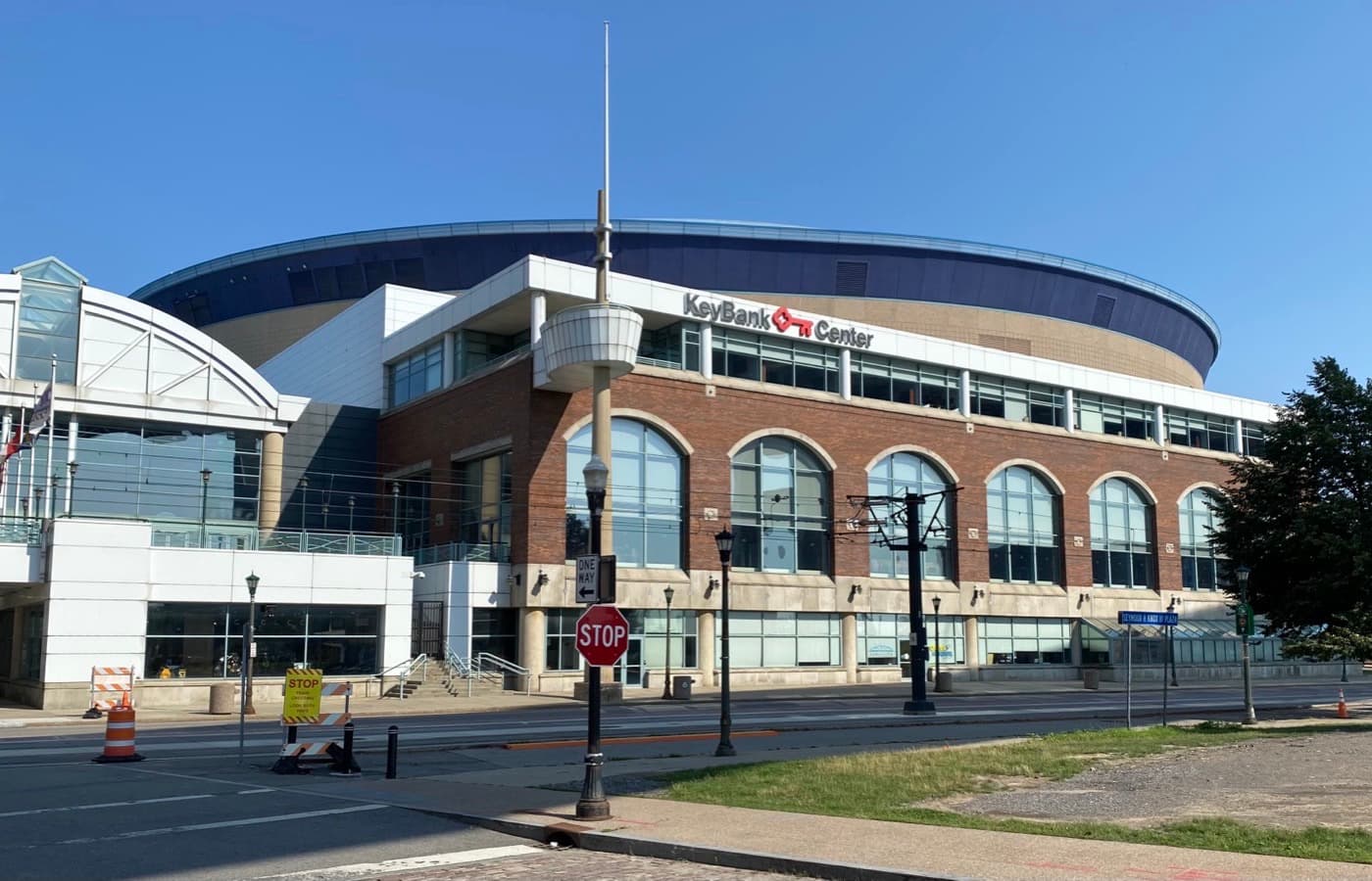 The west exterior of KeyBank Center in downtown Buffalo, seen from Main and Prime Streets at Canalside, with the arena’s curved roofline and KeyBank Center signage