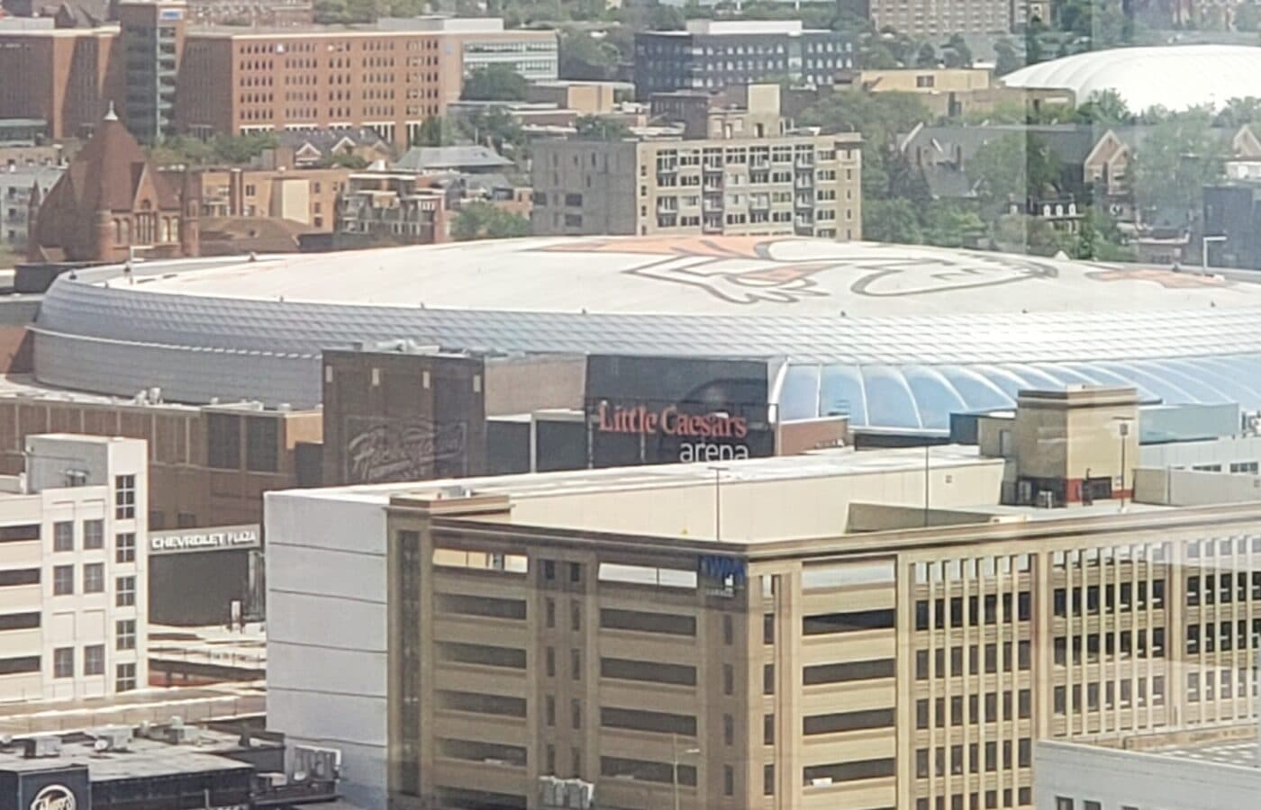 Aerial view of Little Caesars Arena’s roof and signage in downtown Detroit