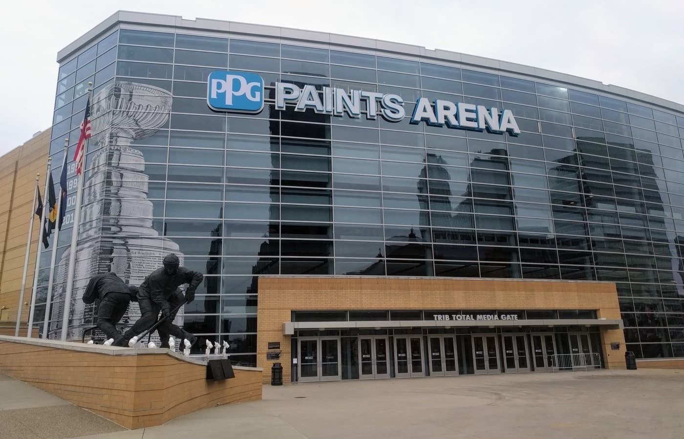 PPG Paints Arena’s glass facade with the Stanley Cup mural, a statue of hockey players and the Trib Total Media Gate in Pittsburgh